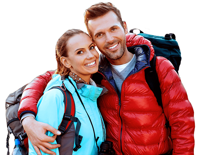 Smiling man and woman with hiking gear