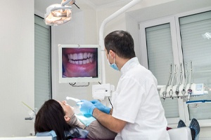 Dentist and patient discussing Chao Pinhole Surgical Technique