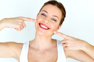 Woman pointing to an attractive smile