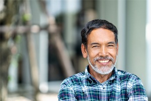 man wearing plaid shirt smiling