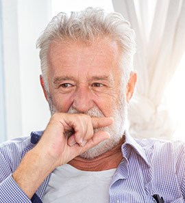 Older man covering his mouth with his hand