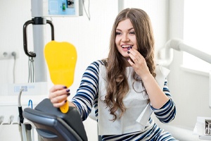 Woman at dentist looking in mirror