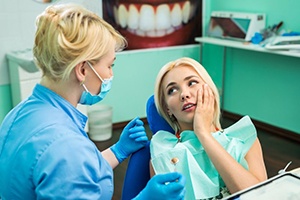 Woman visiting her Lakewood emergency dentist for tooth extraction 