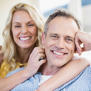 Smiling couple with dental implants in Lakewood