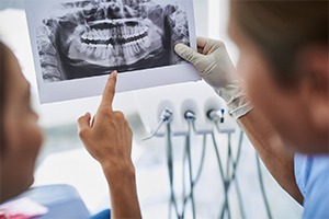 Dentist and patient discuss advanced dental implant procedures in Lakewood