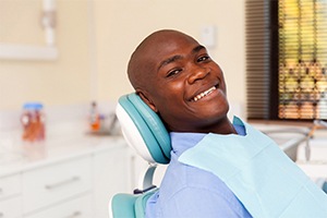 Man smiles after getting dental implants in Lakewood