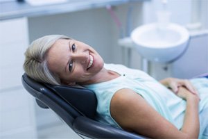 Woman lying back and smiling after Opus laser treatment in Lakewood, CO