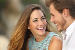 man and woman with bright smiles