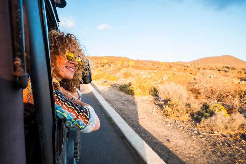 woman smiling while traveling with Invisalign 