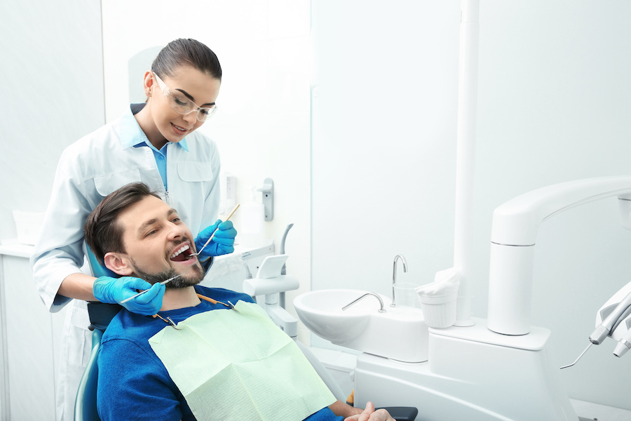 man receiving dental work in office