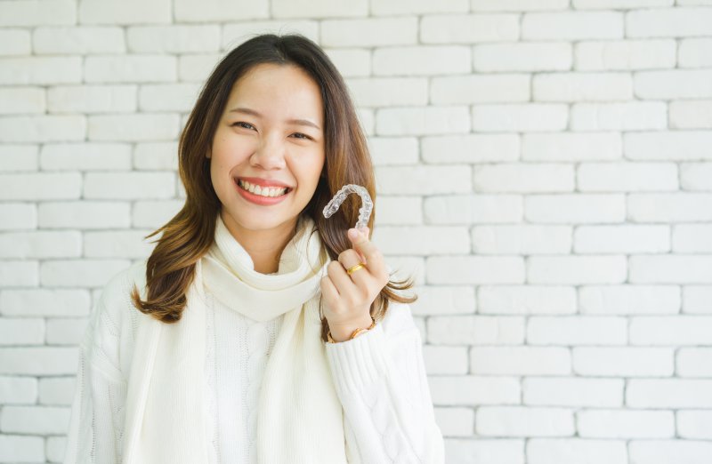 a woman happy with the freedoms of Invisalign in Lakewood